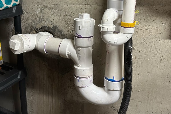 A new PVC pipe drain and trap in a basement